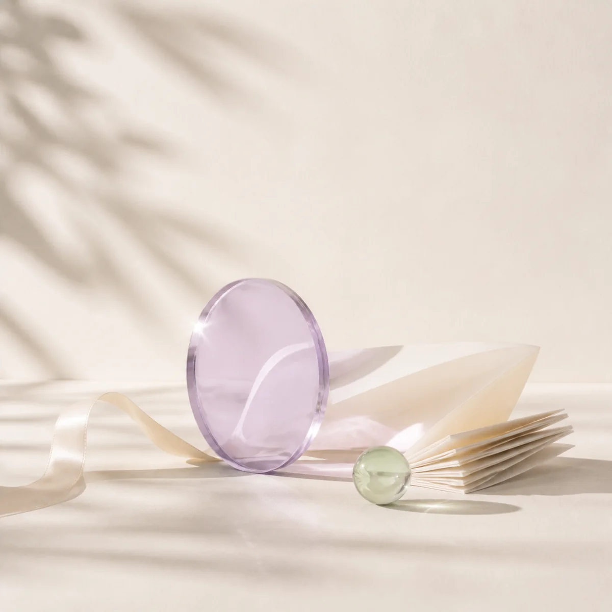 Minimal glass and paper still life representing self-discovery
