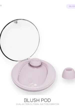Soft pink Blush Pod clitoral suction vibrator with transparent storage lid and removable silicone head on white.