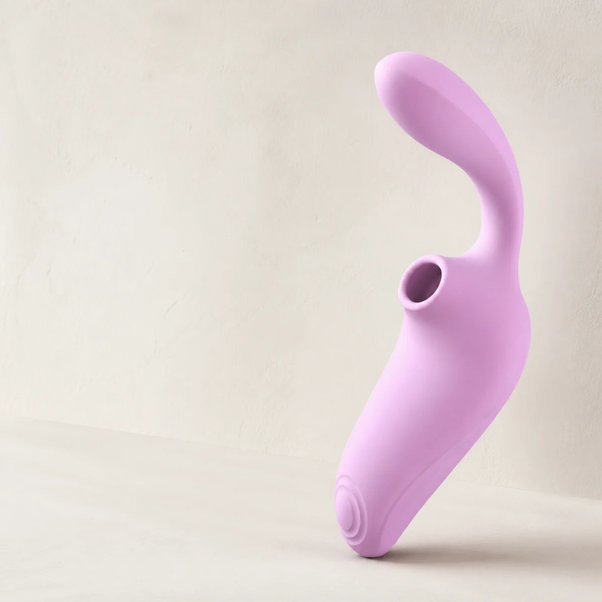 Soft silicone warming personal massager in a bright studio setting